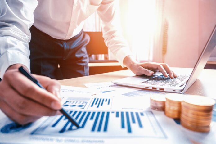 Businessman,Accountant,Or,Financial,Expert,Analyze,Business,Report,Graph,And