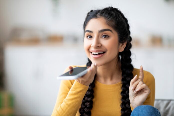 Portrait,Of,Smiling,Young,Indian,Female,Recording,Voice,Message,On